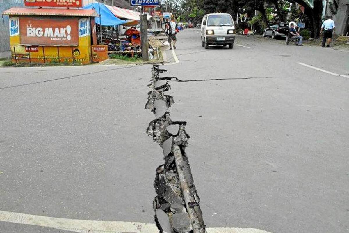 Filipinos revisan una carretera dañada luego del fuerte sismo registrado ayer en la isla de Negros al sur de Manila. (Foto: EFE / VANGUARDIA LIBERAL)