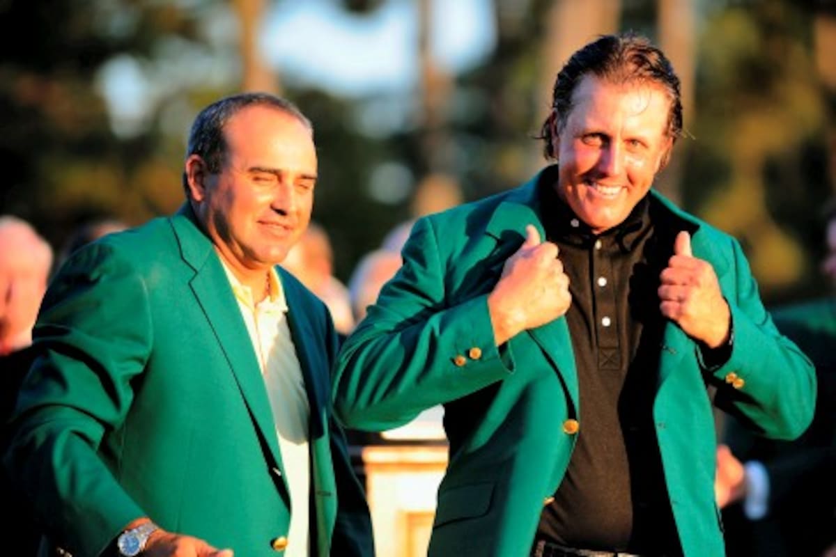 Phil Mickelson (R) of the US receives his green jacket from last years winner Angel Cabrera of Argentina (L) after winning the 2010 Masters Tournament at Augusta National Golf Club on April11, 2010 in Augusta, Georgia. The 39-year-old left-hander finished 72 holes on 16-under par 272. AFP PHOTO/DON EMMERT