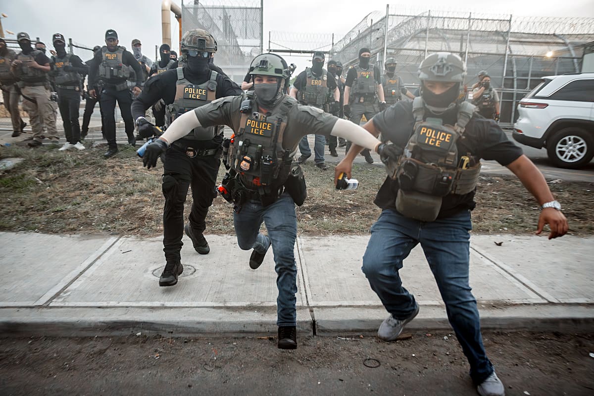 Immigration and Customs Enforcement (ICE) agents charge at the crowd during EFE/EPA/OLGA FEDOROVA