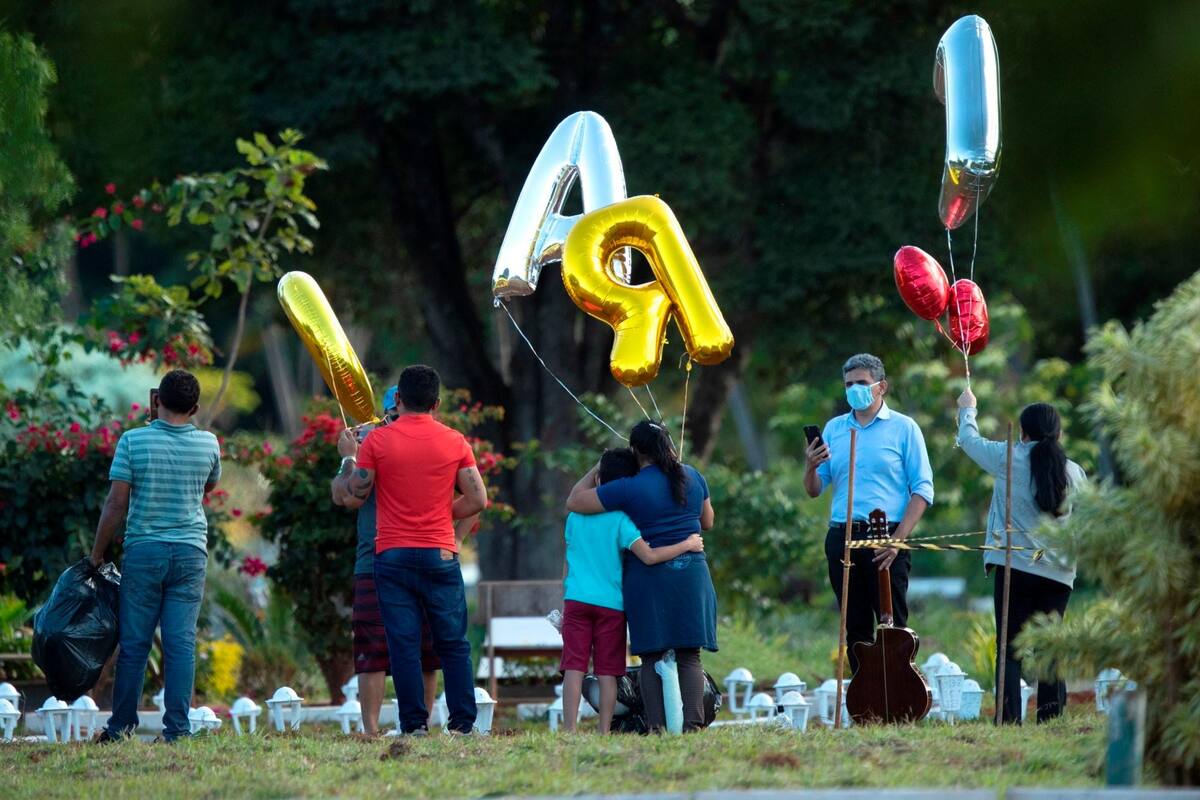 Un reducido número de personas acompaña el entierro de una víctima de covid-19 en el cementerio Campo de Esperanza este jueves, en Brasilia. Brasil está a un paso de convertirse en el segundo foco de la pandemia, al superar a Rusia. (Foto: EFE / VANGUARDIA))
