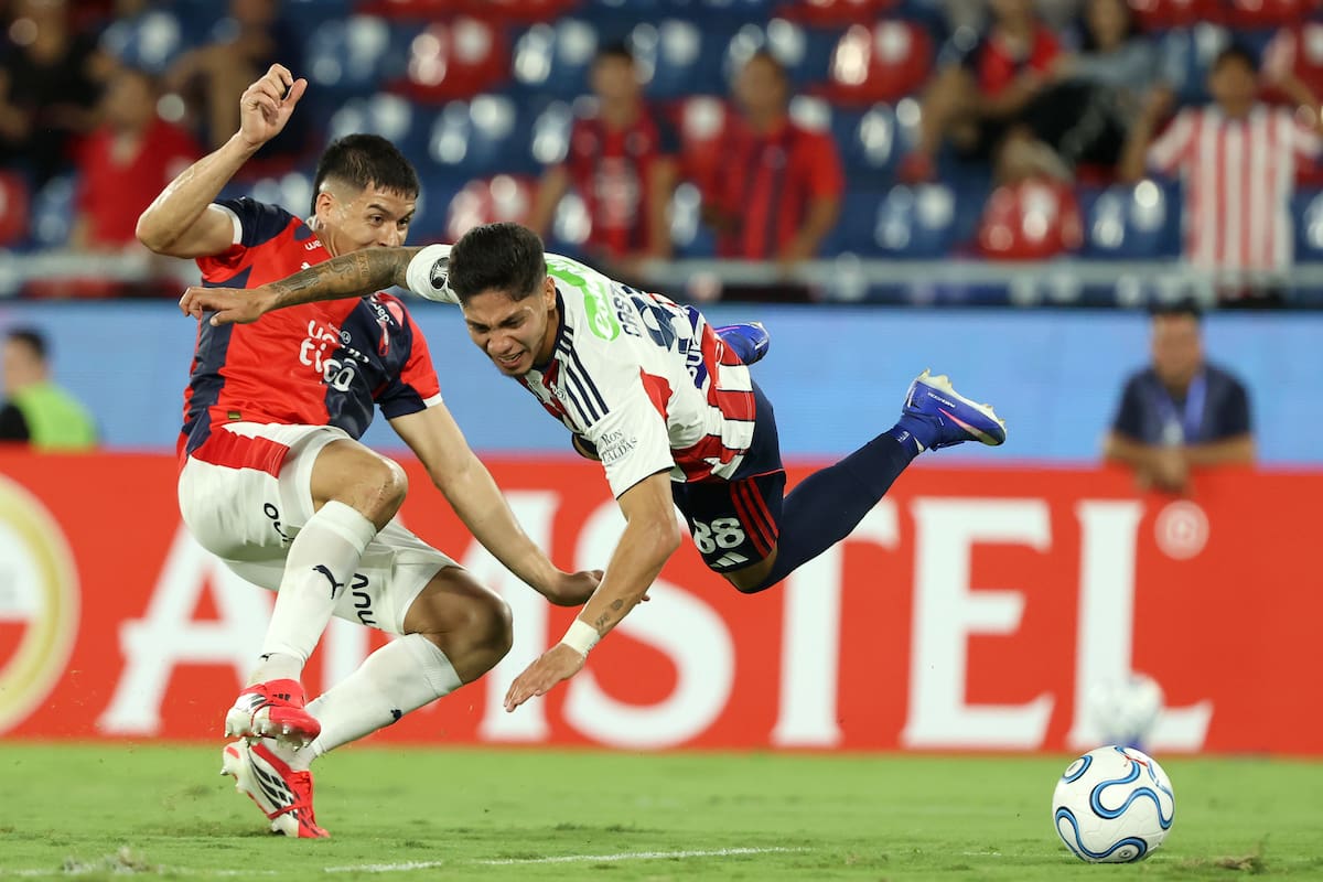 AMDEP3434. ASUNCIÓN (PARAGUAY), 14/04/2026.- Matías Pérez (i) de Cerro Porteño disputa el balón con Bryan Castrillón de Junior este martes, en un partido de la fase de grupos de la Copa Libertadores entre Cerro Porteño y Junior en el estadio La Nueva Olla en Asunción (Paraguay). EFE/ Juan Pablo Pino
