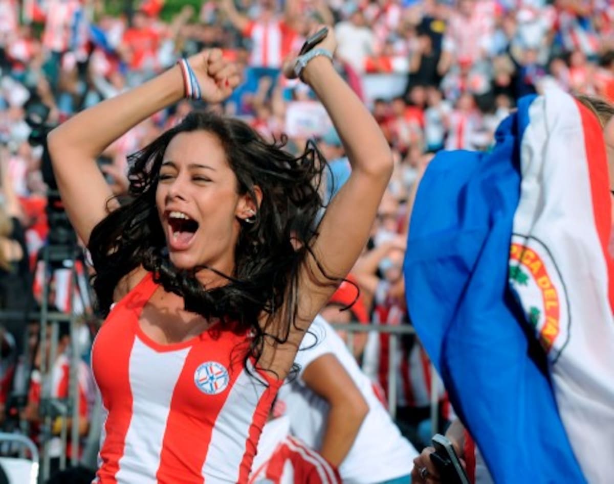 (FILE) Picture taken on June 14, 2010 of Paraguayan model Larissa Riquelme celebrating a goal of Paraguay against Italy as she watches the FIFA WC South Africa 2010 football match on a screen in Asuncion. Riquelme -now known as "the WC girlfriend"-- has promised that if her team gets to the semifinals she would strip off in front of the Argentinian television. AFP PHOTO / Norberto Duarte