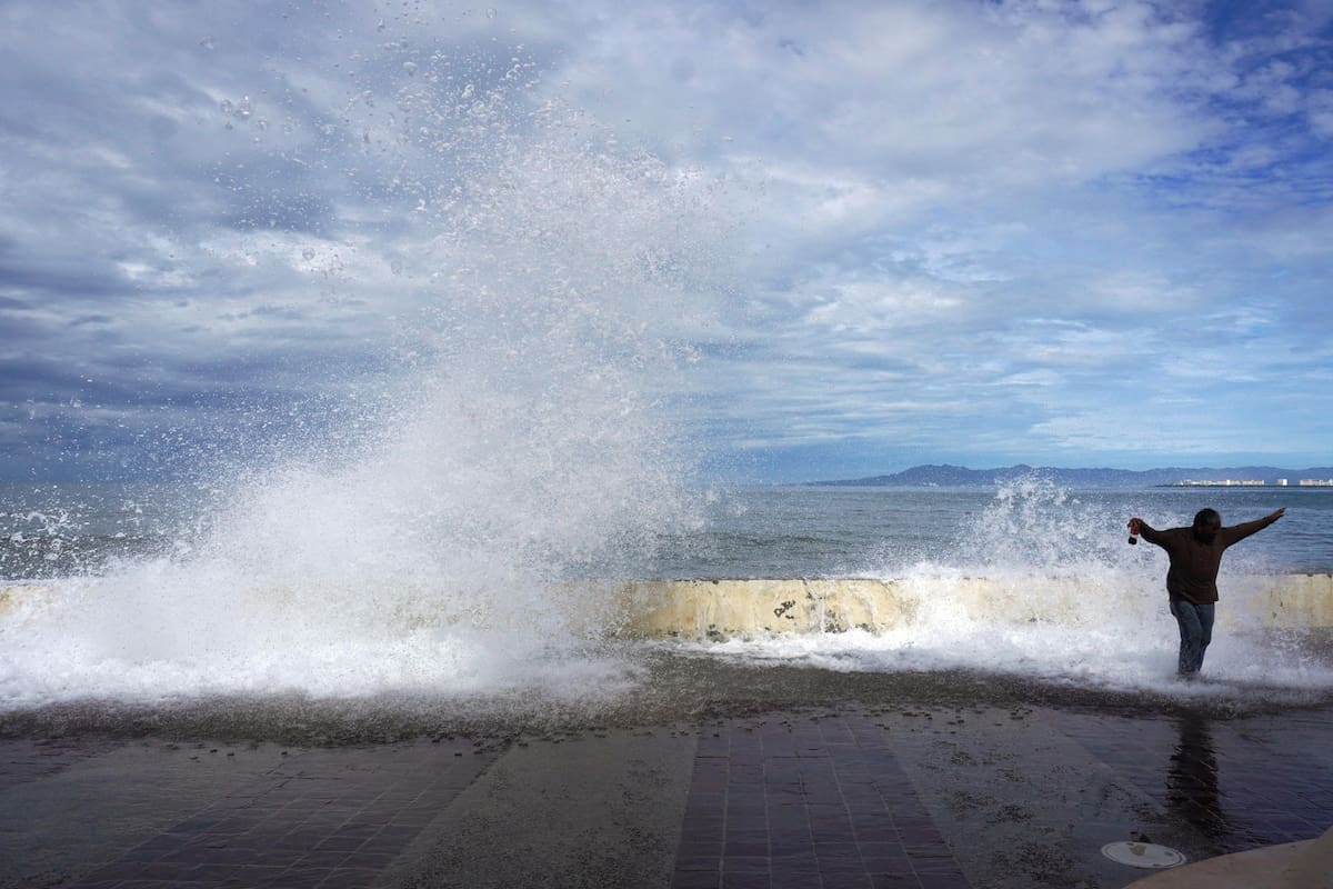 MEX5389. PUERTO VALLARTA (MÉXICO), 12/10/2026.- Una persona camina frente a la playa este lunes, en Puerto Vallarta (México). El huracán Simón se debilitó a categoría 2 frente a las costas del Pacífico mexicano, aunque mantiene la amenaza de fuertes lluvias, vientos y oleaje elevado en los estados de Jalisco, Nayarit y Sinaloa, informó el Servicio Meteorológico Nacional (SMN). EFE/ Arturo Montero