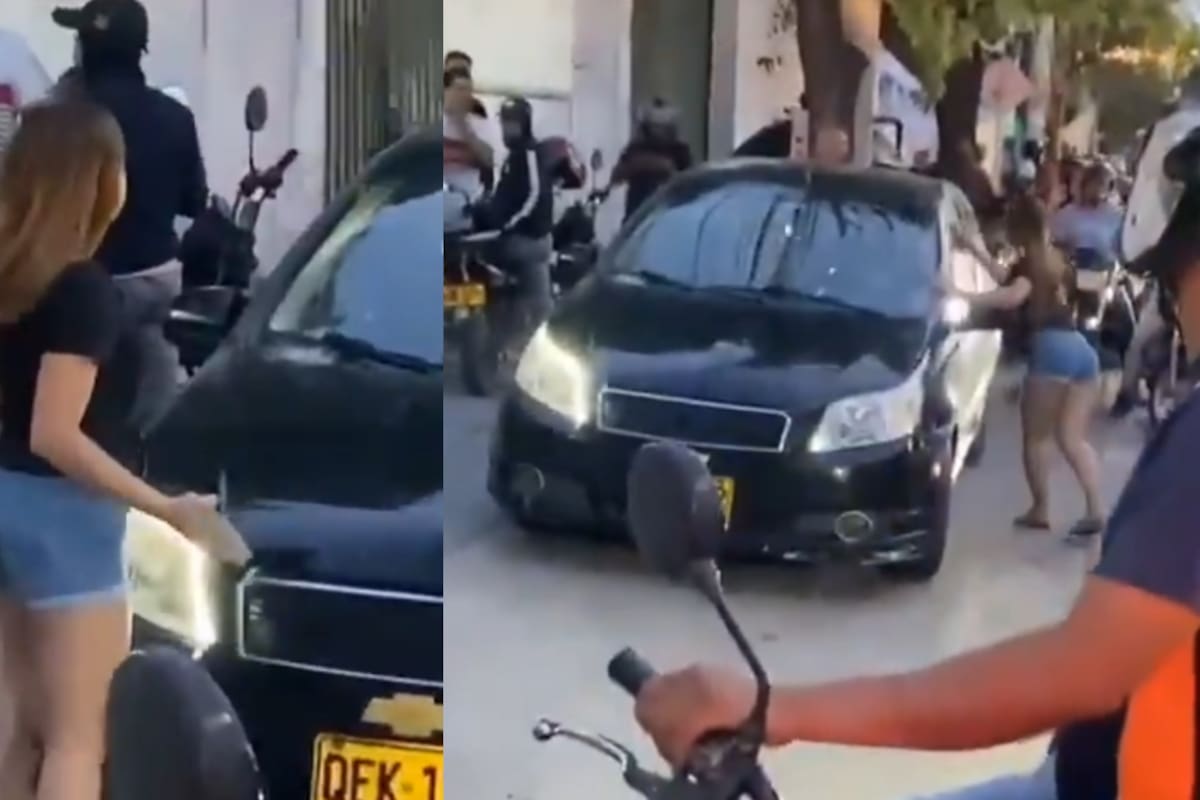 Momento en que una joven, visiblemente alterada, lanza piedras al carro donde sorprendió a su padre con otra mujer, en plena avenida del Libertador, Santa Marta.