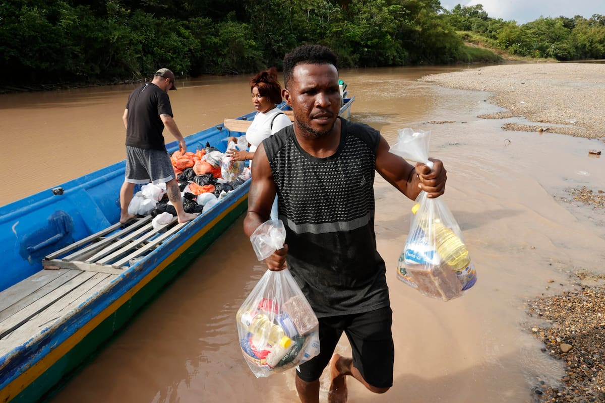 Una persona sostiene bolsas este viernes con ayudas humanitarias por el terremoto de magnitud 7,4 del pasado lunes, en el río San Juan en La Encharca. Seis días después del terremoto, La Encharca, una remota comunidad ubicada a orillas del río Suruco, en el municipio chocoano de Medio San Juan, muestra otra cara de la emergencia en Colombia: la de quienes viven lejos de los centros urbanos y afrontan las consecuencias del sismo sin servicios básicos y bajo la presión de grupos armados ilegales. EFE/ Mauricio Dueñas Castañeda