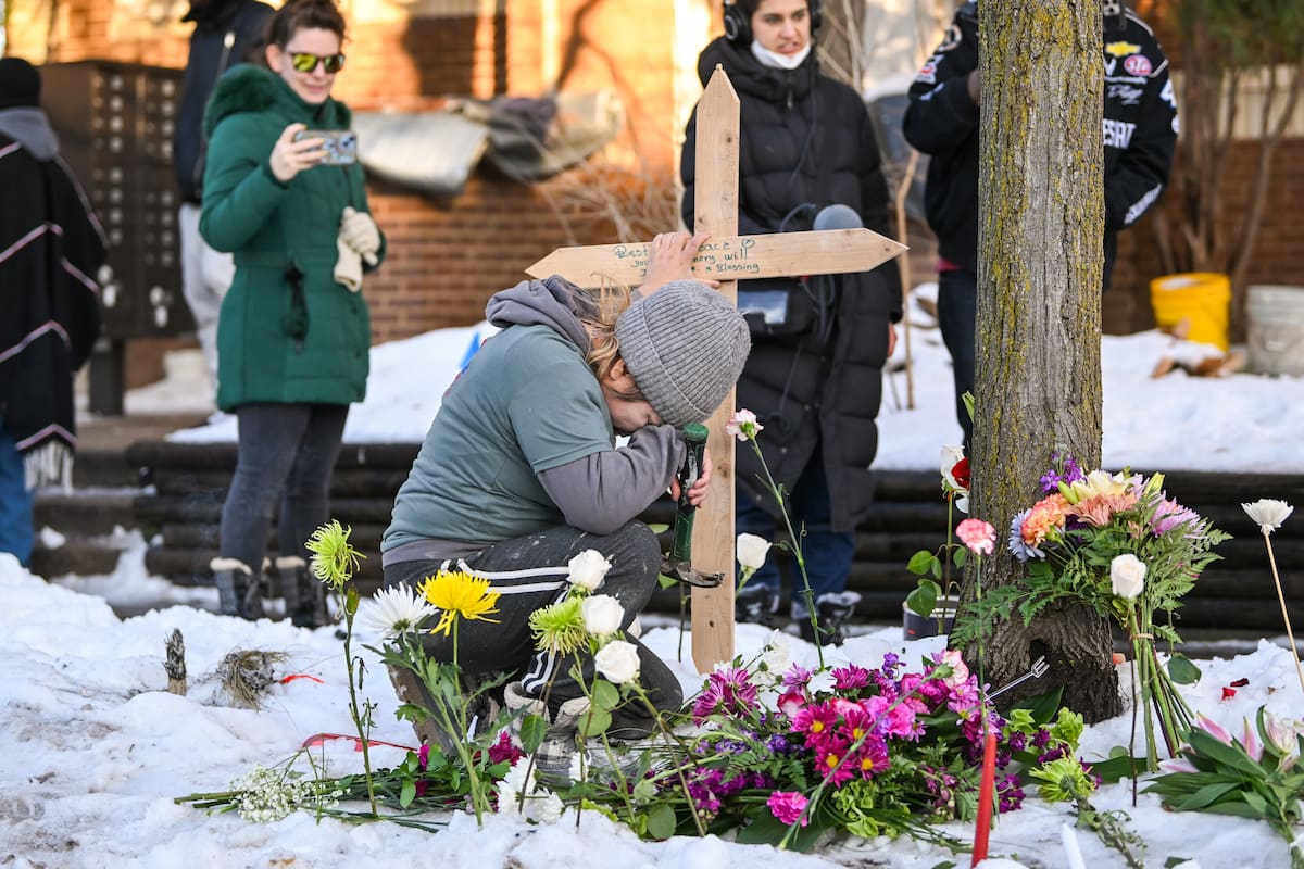 Una mujer ora en un monumento improvisado en el lugar en el que una mujer fue asesinada a tiros por un agente de Inmigración y Control de Aduanas (ICE) en Minneapolis, Minnesota. EFE/EPA/CRAIG LASSIG