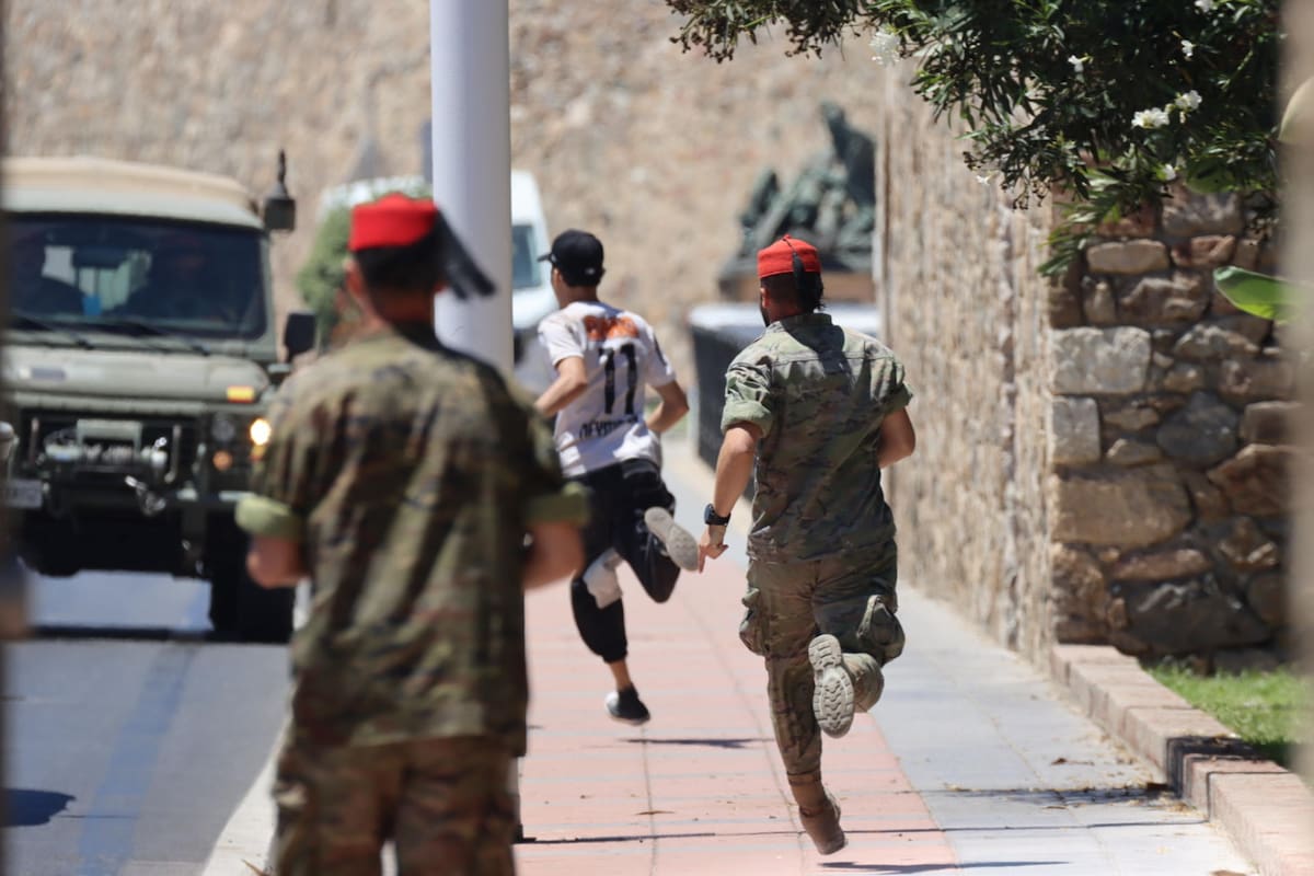 Medios desplegados intentan detener a un migrante este domingo en Ceuta. EFE/Reduán