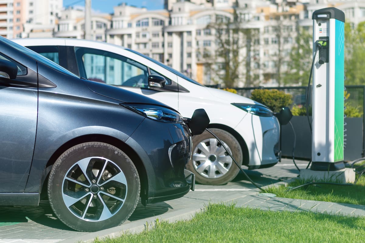 Two charging electric cars at charge station in the city