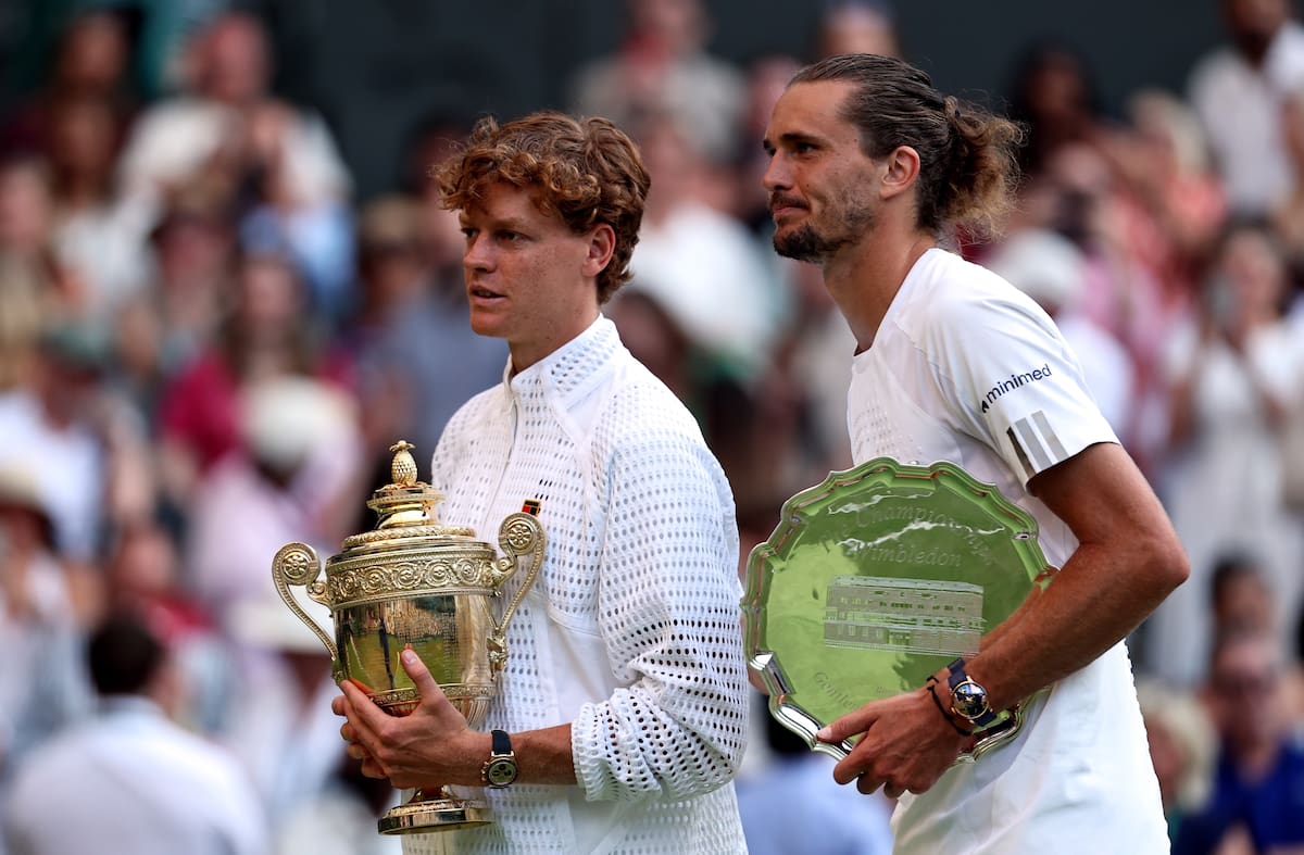 LONDON (United Kingdom), 12/07/2026.- Jannik Sinner of Italy (L) celebrates with the trophy after winning the Men's Singles final against Alexander Zverev of Germany (R), with his runner-up trophy, at the Wimbledon Championships in London, Britain, 12 July 2026. (Tenis, Alemania, Italia, Reino Unido, Londres) EFE/EPA/NEIL HALL